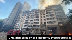 Rescuers work at a residential building damaged by a Russian missile strike in Kyiv on June 26.