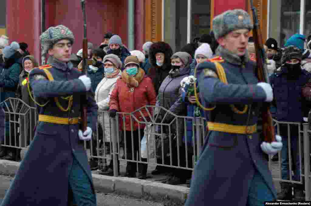 Жителі Донецька спостерігають за церемонією вшанування пам’яті жертв обстрілу 22 січня 2015 року тролейбусної зупинки «Донецькгірмаш». Українська сторона стверджує, що обстріл влаштували самі проросійські бойовики для дискредитації ЗСУ, а проросійське угруповання «ДНР» звинувачує Україну. Непідконтрольний Донецьк, ОРДЛО. 22 січня 2022 року