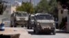 Vehicule blindate ale armatei israeliene intră în orașul palestinian Jenin în timpul unei operațiuni militare în nordul Cisiordaniei ocupate, pe 21 mai 2025.