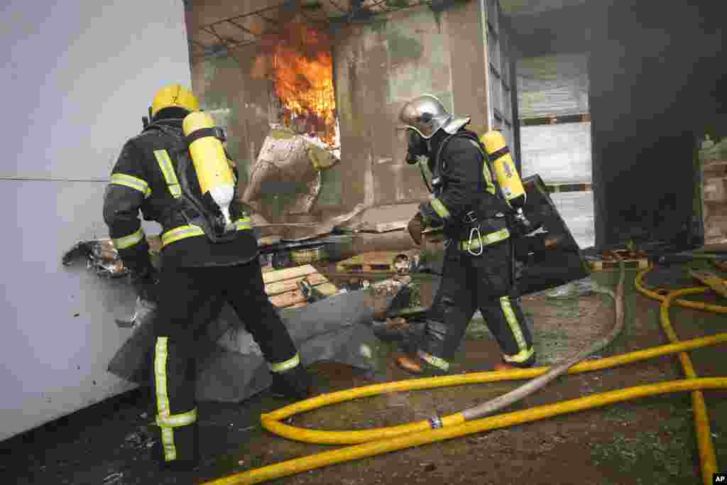 Firefighters tackle the blaze at the site of the Russian attack. 