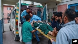 An injured woman living in a village near the Line of Control between India and Pakistan in Kashmir is brought to a hospital following shelling by Pakistan on May 7. 