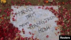 A note is pictured on the ground at the entrance of the Army Public School, which was attacked by Taliban in Peshawar.