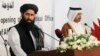 File photo of Taliban spokesman Muhammad Naeem (L) in Doha, Qatar.