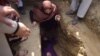 FILE: Afghan civil society activist women weep and lie on the grave of Afghan woman Farkhunda, 27, who was lynched by an angry mob, at the cemetery in central Kabul in March 2015.