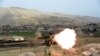 FILE: A member of the Afghan security force fires a rocket-propelled grenade (RPG) launcher during an ongoing an operation against Islamic State (IS) militants in eastern Afghanistan.