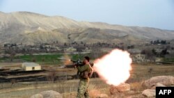 FILE: A member of the Afghan security force fires a rocket-propelled grenade (RPG) launcher during an ongoing an operation against Islamic State (IS) militants in eastern Afghanistan.