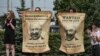 BELARUS -- Protesters hold the posters with Belarusian President Alyaksandr Lukashenka portraits standing near enter of the factory of refrigerators, freezers and washing machines Atlant and calling workers to join in strike and protests in Minsk, August 