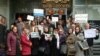 Nasrin Sotoudeh (center, holding flower) demonstrates in front of Iran's Bar Association last month along with a number of supporters.