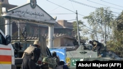 Pakistani soldiers outside an Agriculture Training Institute after an attack by Taliban militants in Peshawar on December 1.