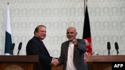 Pakistani Prime Minister Nawaz Sharif (L) shaking hands with Afghan President Ashraf Ghani in Kabul on May 12.