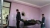 Afghan security officials carry a body of a suspected militant, in Mazar-e Sharif on January 5.