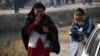 Distraught parents whose children are trapped in the school arrive close to the school following an attack at the Army run school in Peshawar on December 16.