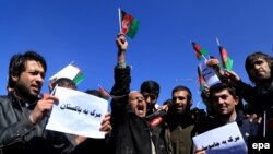 Afghans shout slogans protesting Pakistan's last week cross-border rocket shelling, in Kabul, on February 23.